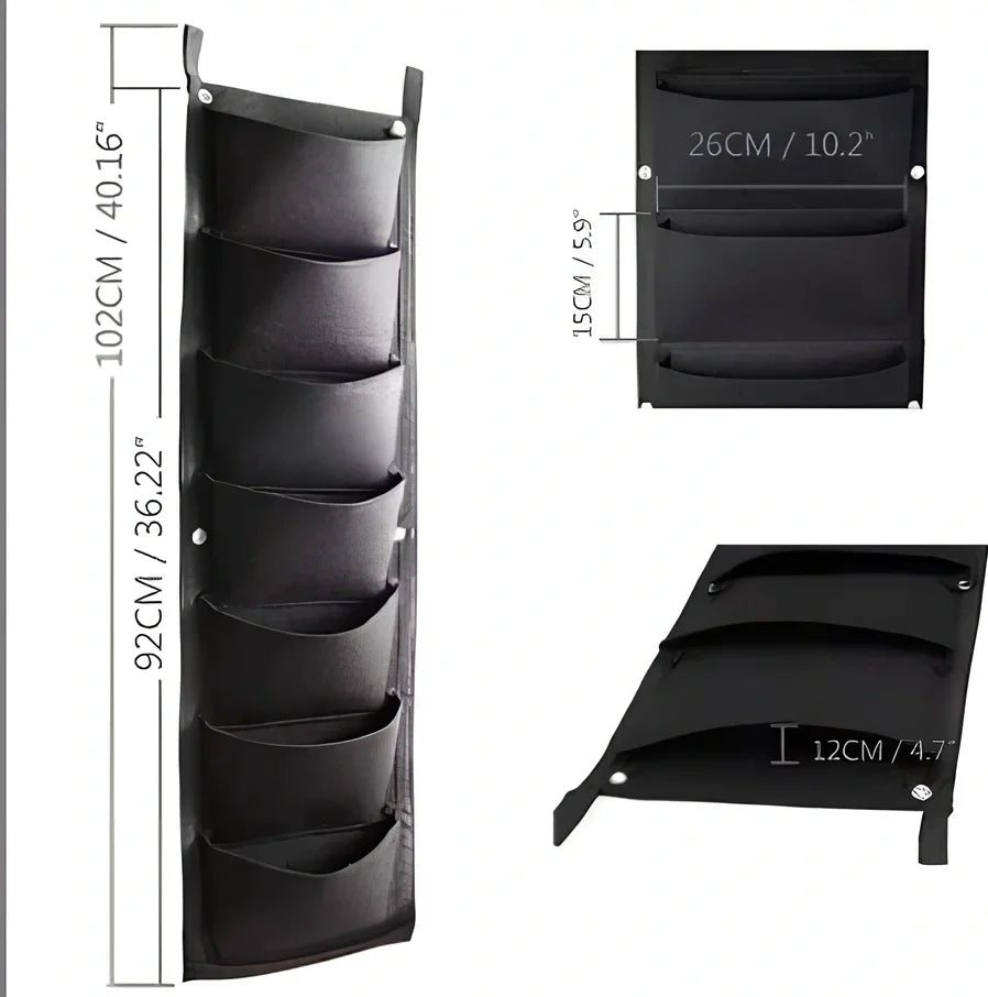 Vertical wall garden planting bag with 18 pockets hanging on outdoor wall with growing herbs