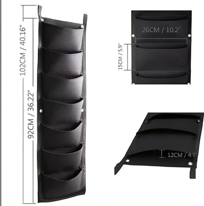 Vertical wall garden planting bag with 18 pockets hanging on outdoor wall with growing herbs