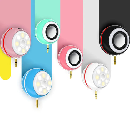 Compact, portable lighting and audio accessory for smartphone with adjustable brightness and built-in speaker