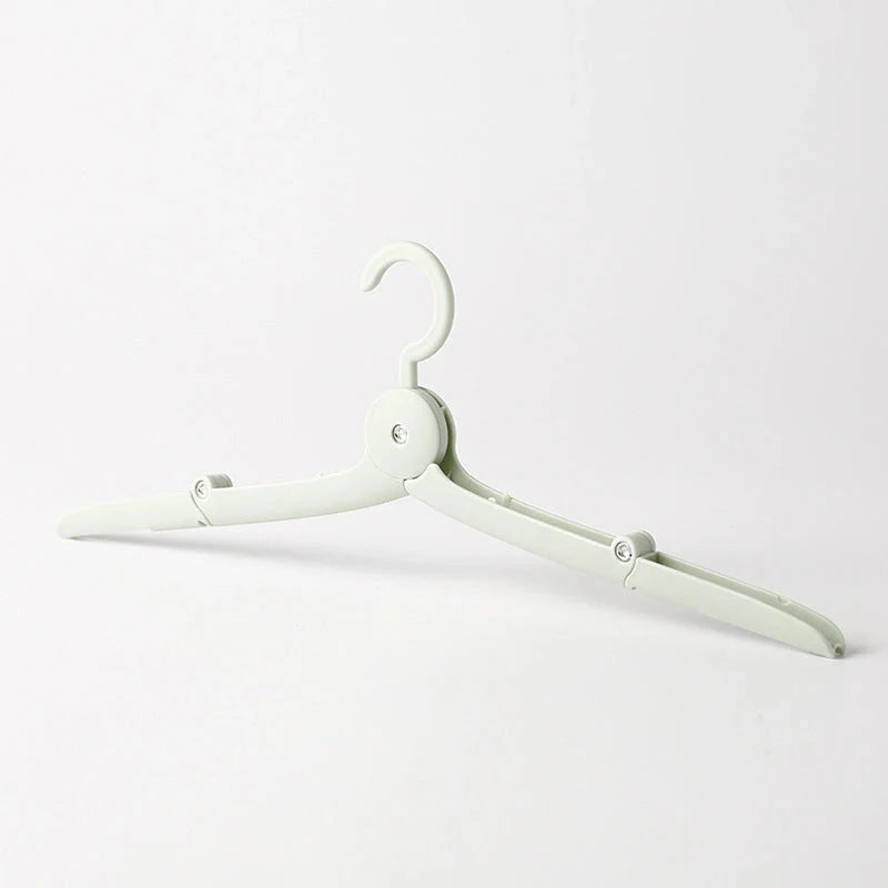 Compact folding hanger in blue, green, and pink colors, showing telescopic design for travel and dorm use
