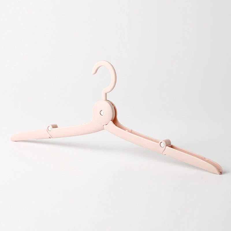 Compact folding hanger in blue, green, and pink colors, showing telescopic design for travel and dorm use
