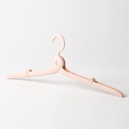 Compact folding hanger in blue, green, and pink colors, showing telescopic design for travel and dorm use