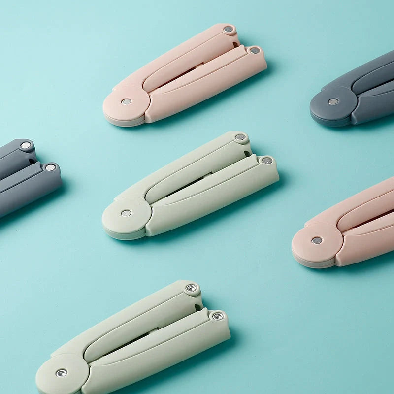 Compact folding hanger in blue, green, and pink colors, showing telescopic design for travel and dorm use