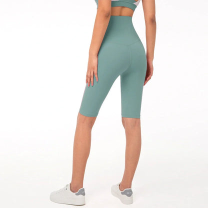 Women's yoga pants with five-point design in tidewater teal colour showing moisture-wicking nylon fabric