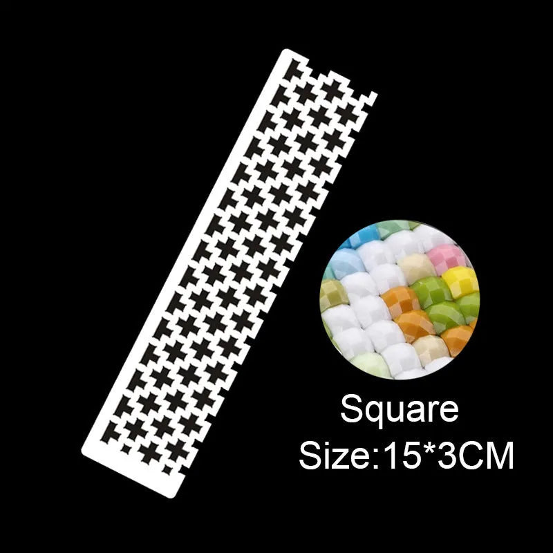Stainless steel diamond painting grid ruler for round and square drills on a craft table.