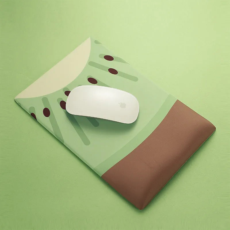 Green kiwi-shaped mouse pad with 20mm thick silicone wrist support on office desk