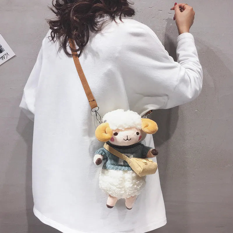 Little Sheep plush crossbody bag in blue, showing square shape, lamb pattern, and zipper.