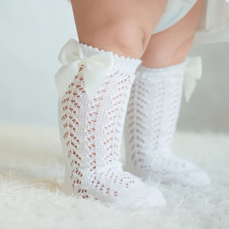 Girls' cotton knee-high socks with decorative bows and hollow-out patterns in navy blue colour