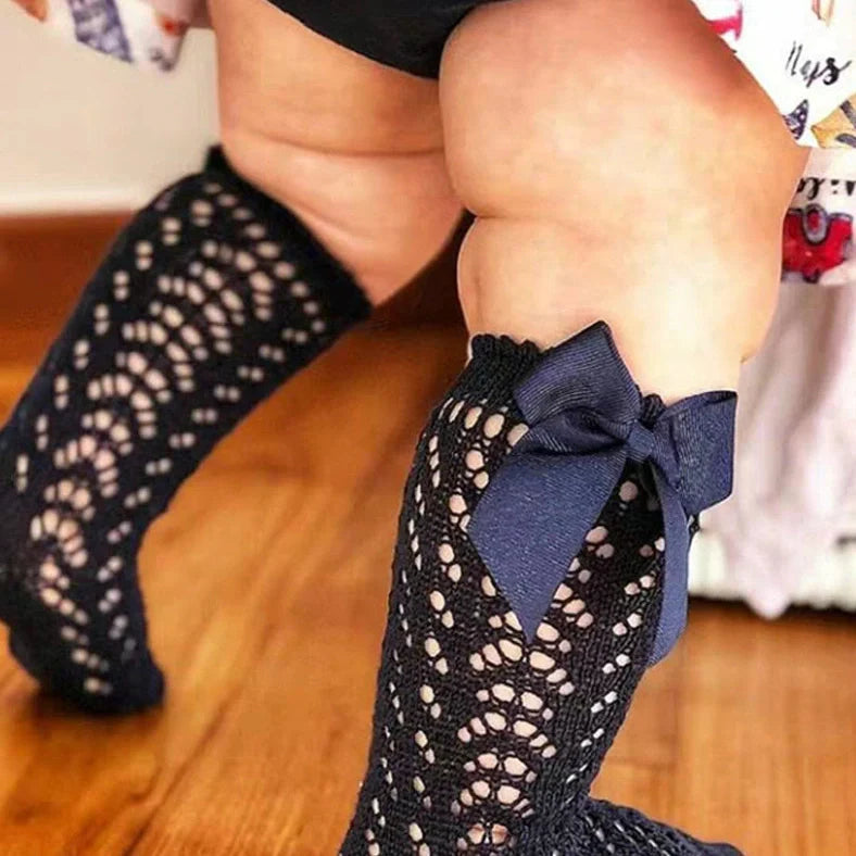 Girls' cotton knee-high socks with decorative bows and hollow-out patterns in navy blue colour