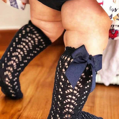 Girls' cotton knee-high socks with decorative bows and hollow-out patterns in navy blue colour