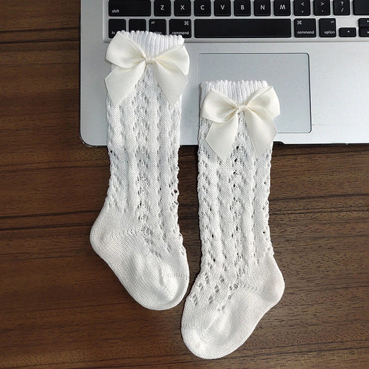 Girls' cotton knee-high socks with decorative bows and hollow-out patterns in navy blue colour