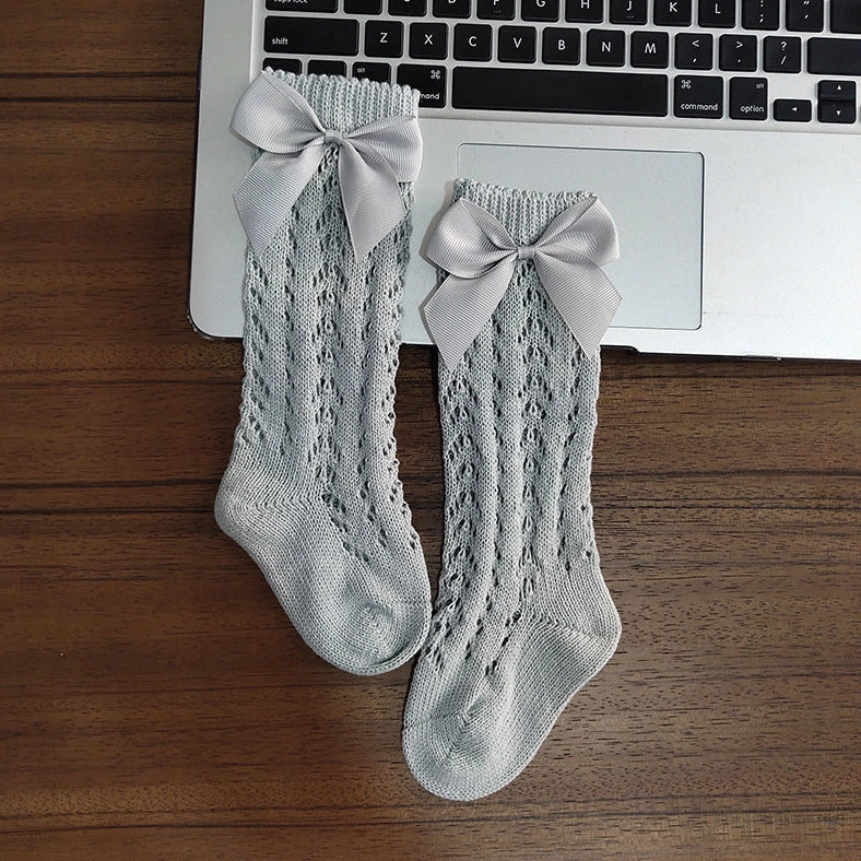 Girls' cotton knee-high socks with decorative bows and hollow-out patterns in navy blue colour