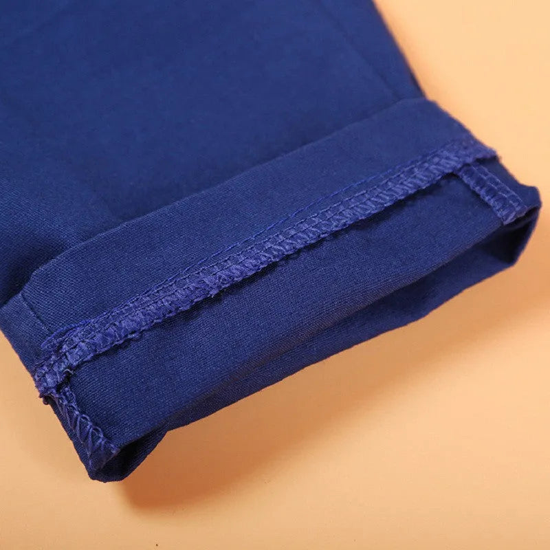 Blue boys' suit clothing set with vest, tie, turtleneck and trousers on hanger
