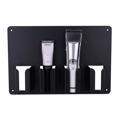 Black plastic wall-mounted hairdressing clipper display box holding four electric clippers
