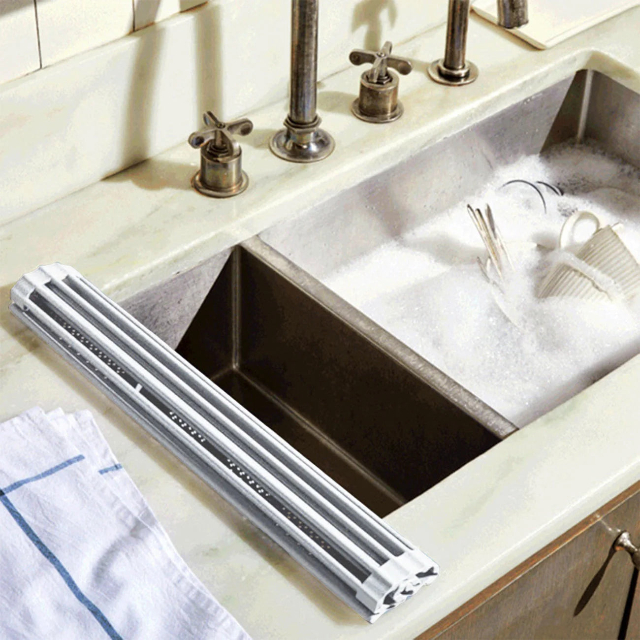 Foldable stainless steel dish rack with utensil caddy, perfect for kitchen organization