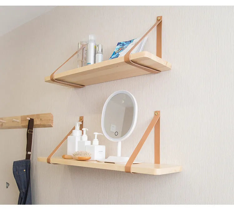 Natural pine wood wall mounted shelf with books and small items organised on it.