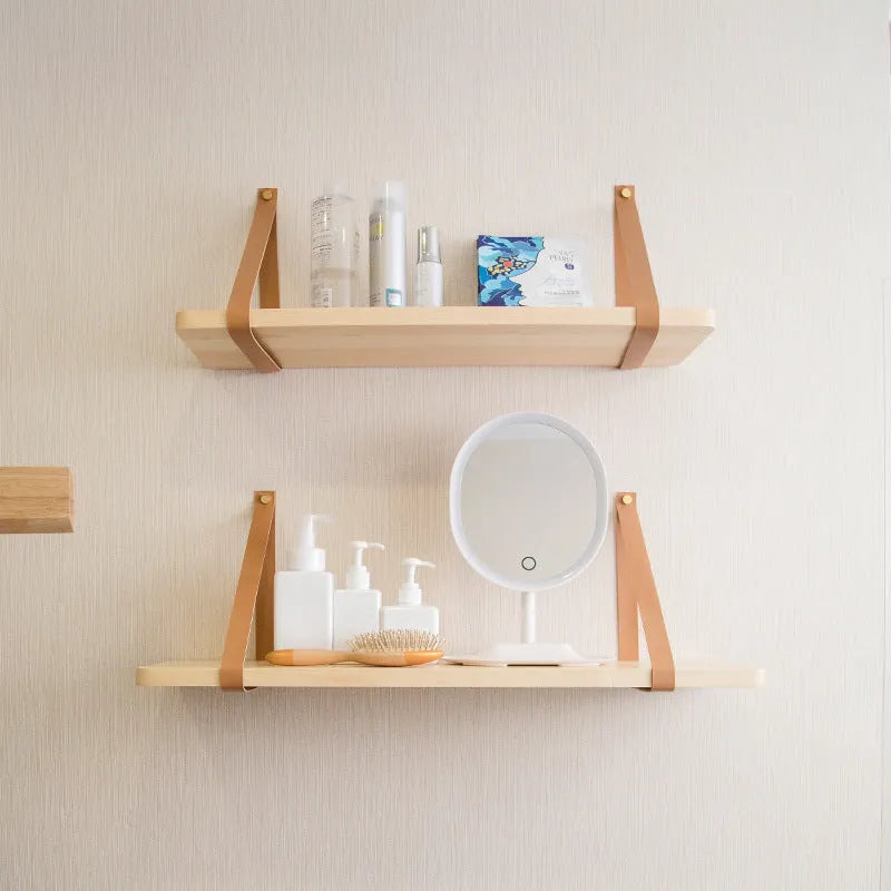 Natural pine wood wall mounted shelf with books and small items organised on it.
