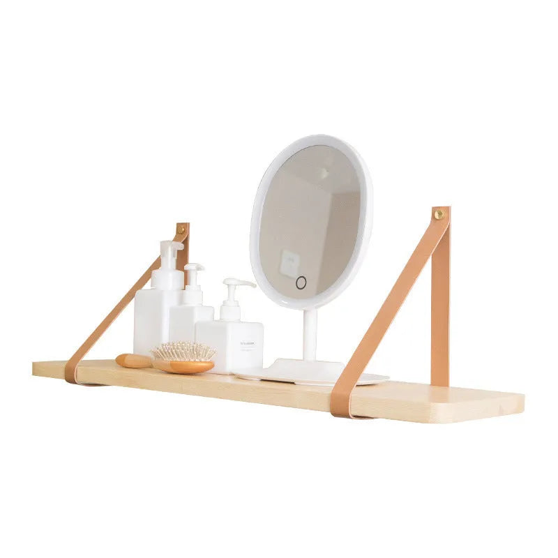 Natural pine wood wall mounted shelf with books and small items organised on it.