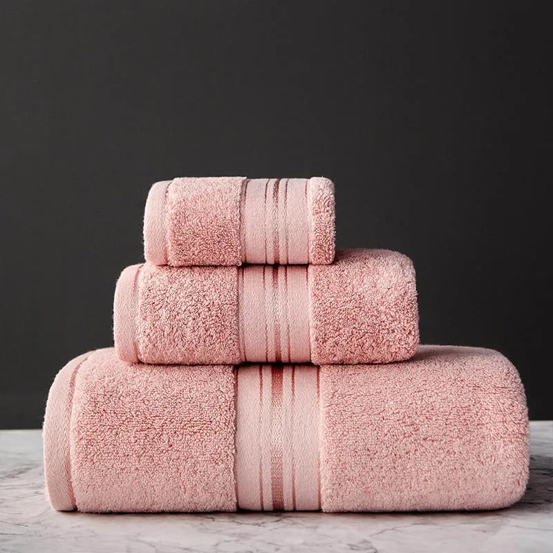 Three-piece cotton towel set showing bath towel, towel, and square scarf in coordinating colours