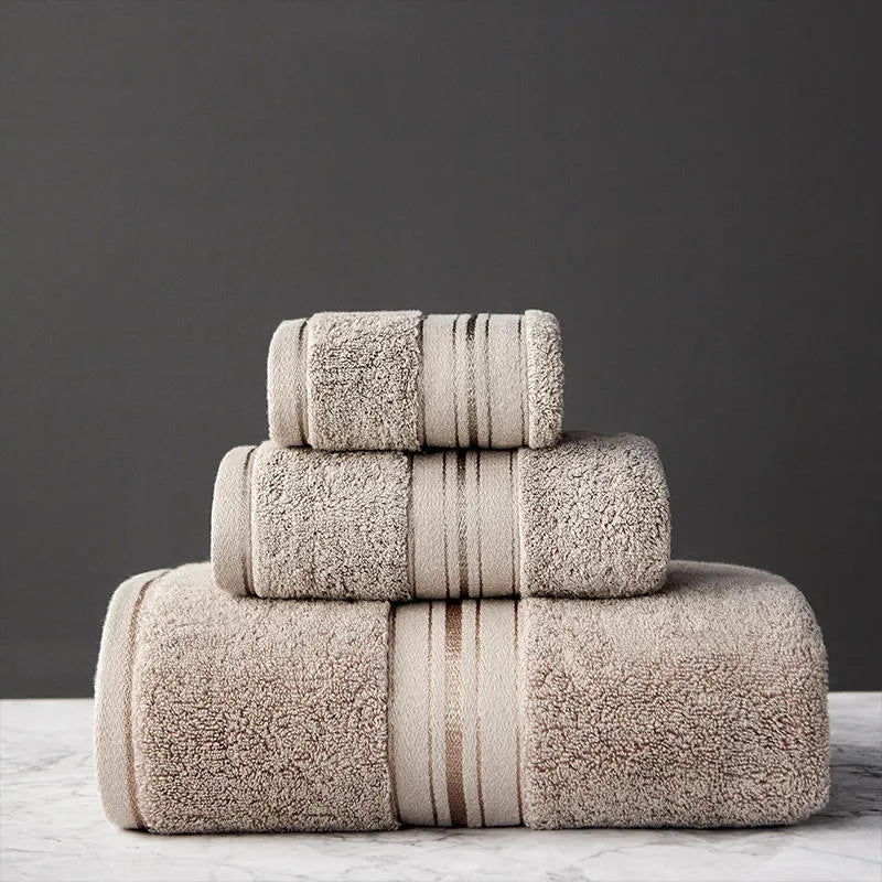 Three-piece cotton towel set showing bath towel, towel, and square scarf in coordinating colours