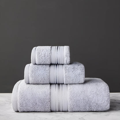 Three-piece cotton towel set showing bath towel, towel, and square scarf in coordinating colours