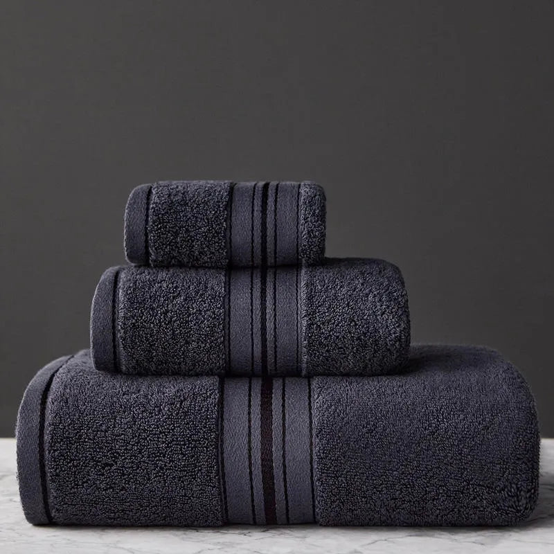 Three-piece cotton towel set showing bath towel, towel, and square scarf in coordinating colours