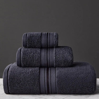 Three-piece cotton towel set showing bath towel, towel, and square scarf in coordinating colours