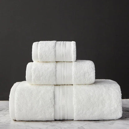 Three-piece cotton towel set showing bath towel, towel, and square scarf in coordinating colours
