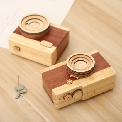 Wooden camera-themed rotating music box in sanding box packaging