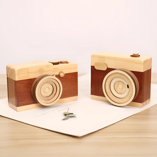 Wooden camera-themed rotating music box in sanding box packaging