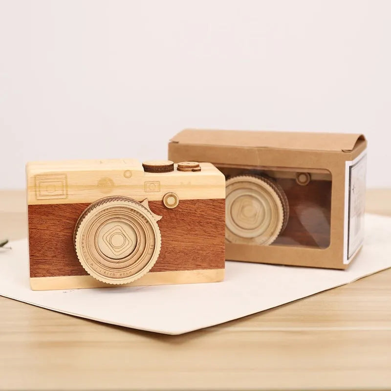 Wooden camera-themed rotating music box in sanding box packaging