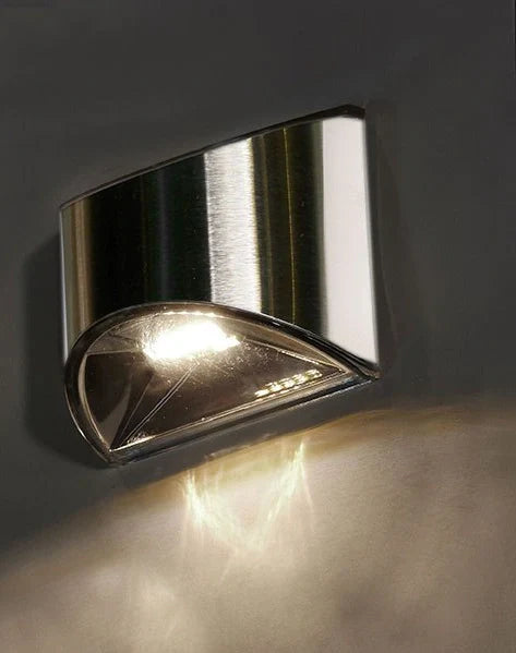 White solar step lights measuring 10cm long on outdoor brick steps with LED illumination