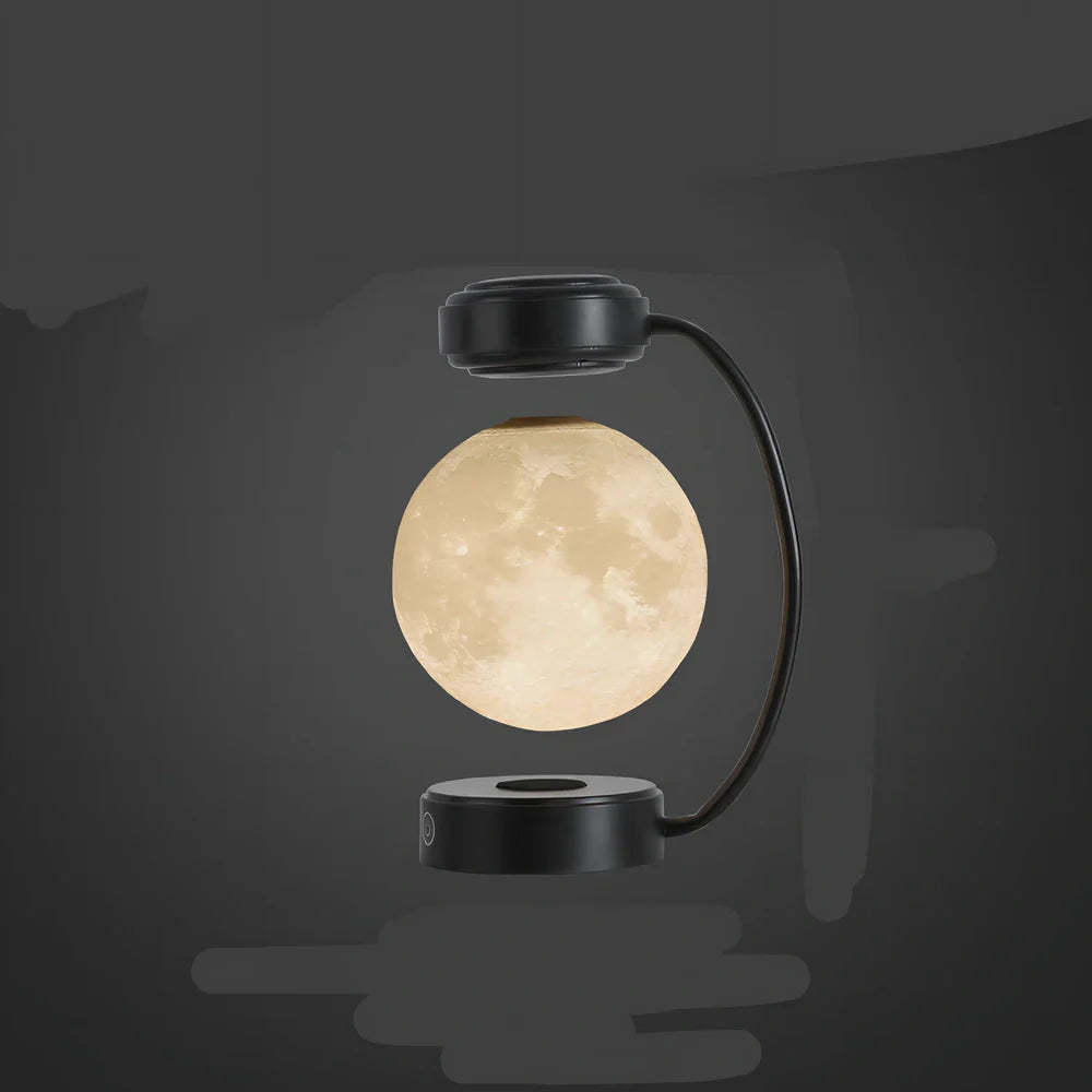 Black magnetic levitation moon lamp floating above base with golden illumination, showing touch control area