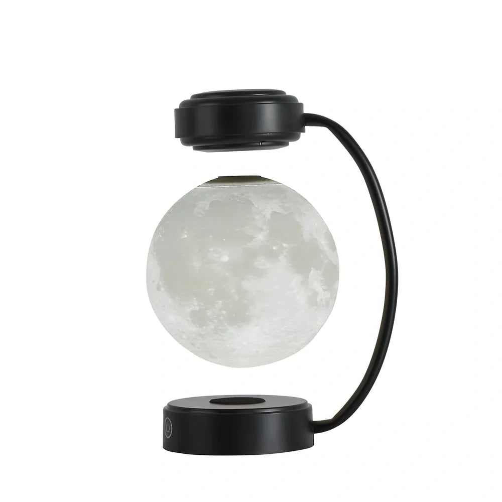 Black magnetic levitation moon lamp floating above base with golden illumination, showing touch control area