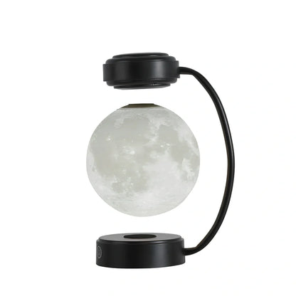 Black magnetic levitation moon lamp floating above base with golden illumination, showing touch control area