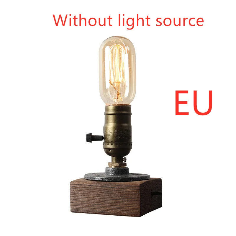 Compact wooden and iron water pipe table lamp on a table.