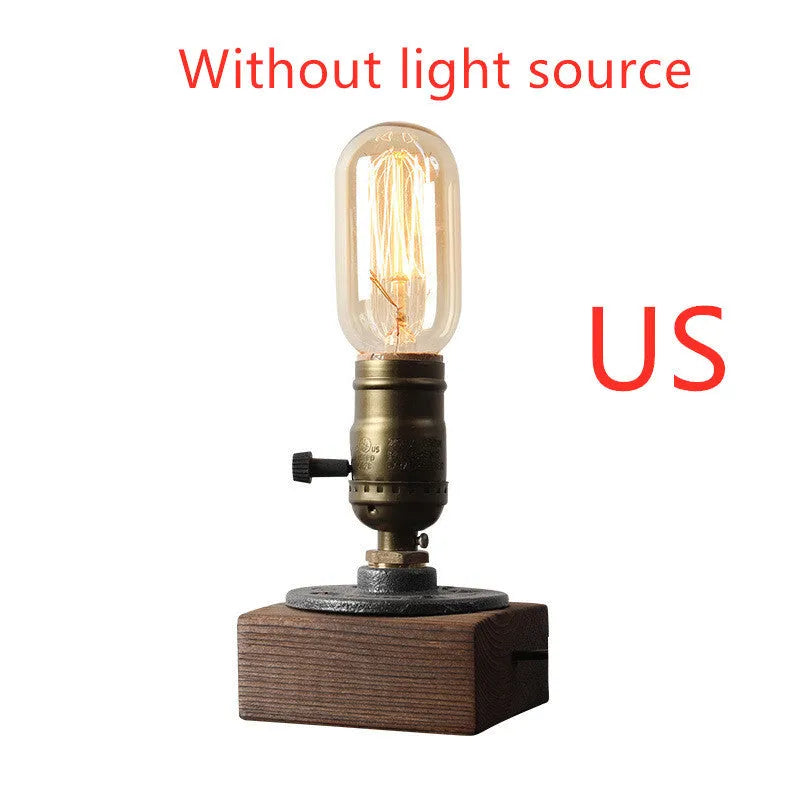 Compact wooden and iron water pipe table lamp on a table.