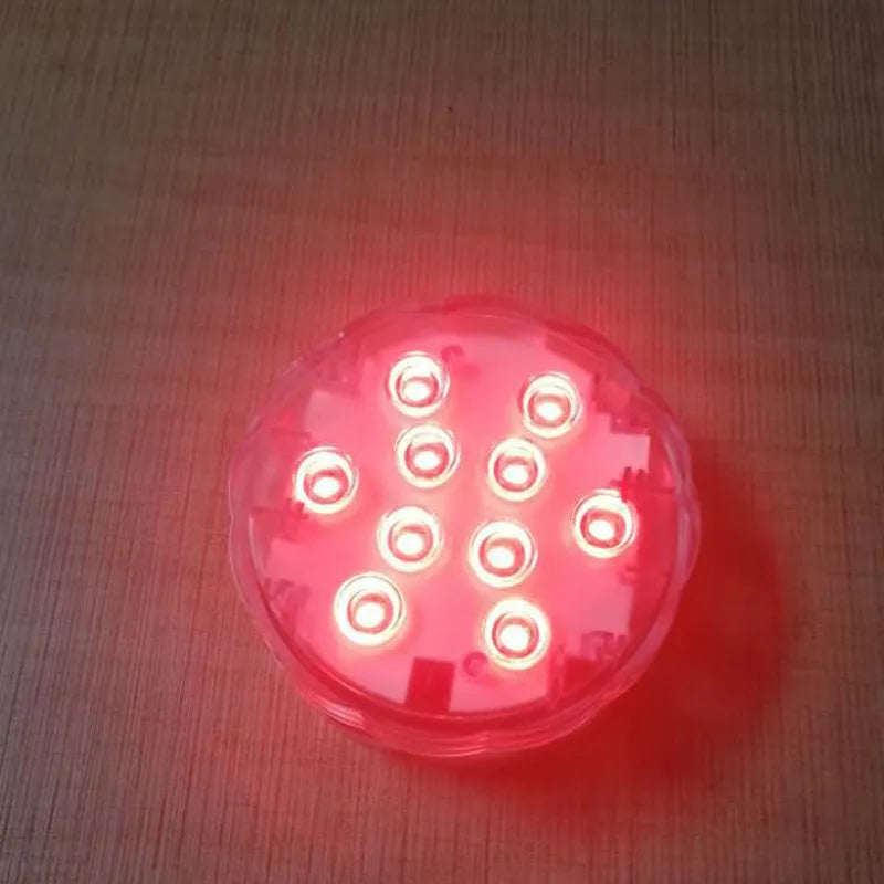 White waterproof remote control LED light with IP68 rating for pools and gardens.