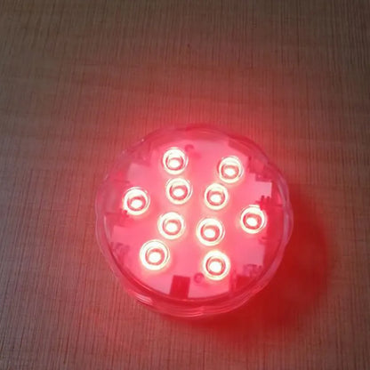 White waterproof remote control LED light with IP68 rating for pools and gardens.