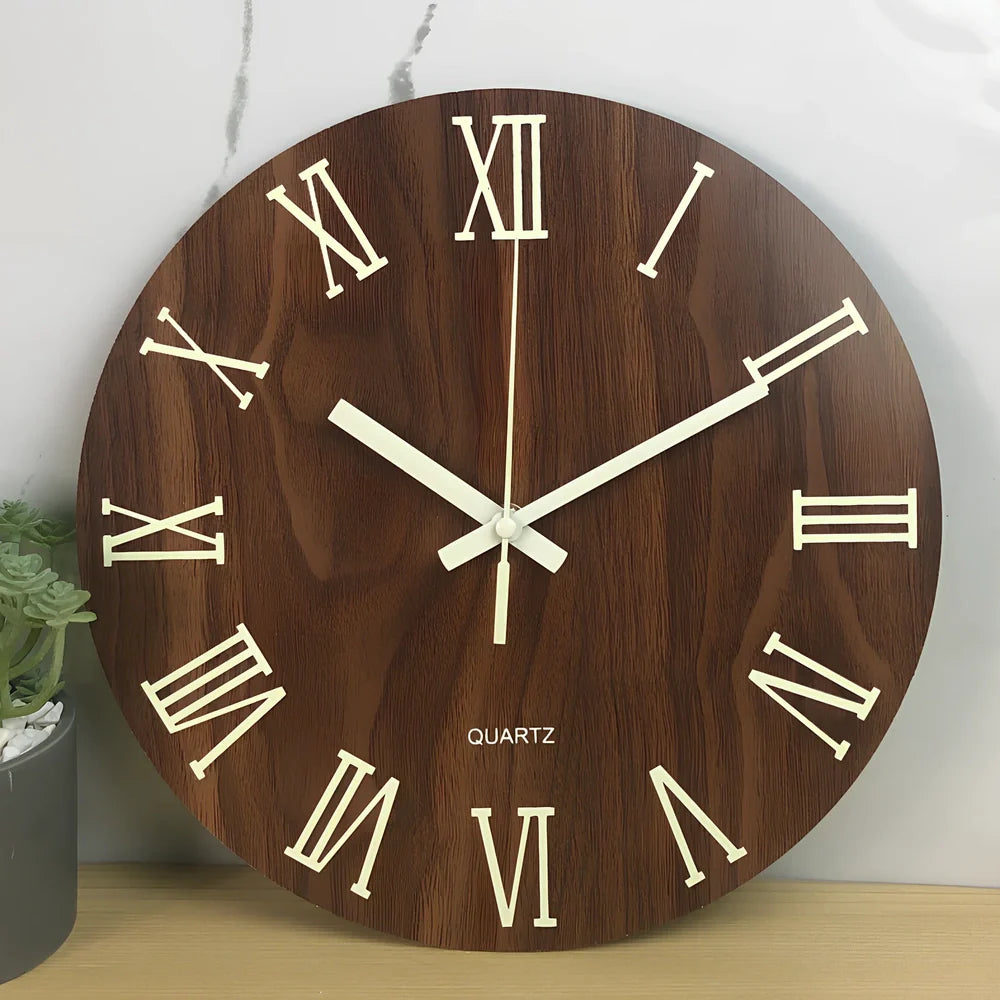 Round wood grain luminous wall clock with glowing numbers in dark room setting
