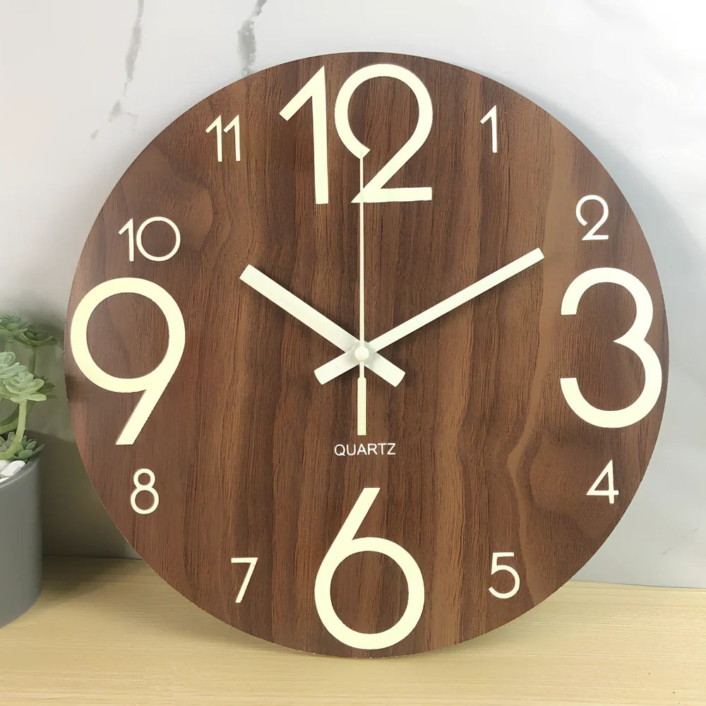 Round wood grain luminous wall clock with glowing numbers in dark room setting