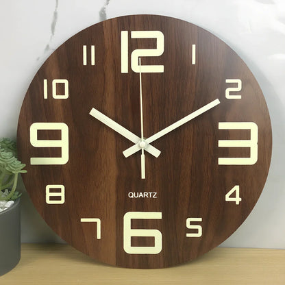 Round wood grain luminous wall clock with glowing numbers in dark room setting