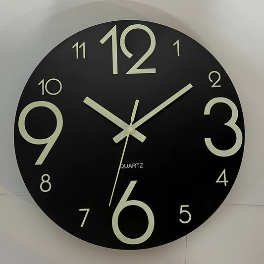 Round wood grain luminous wall clock with glowing numbers in dark room setting