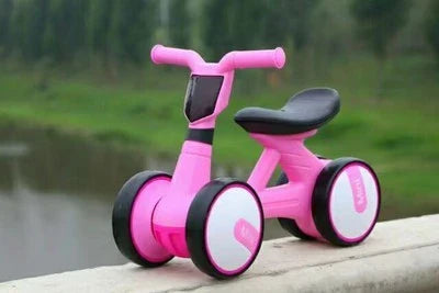 A stylish no-pedal balance bike with three wheels, vibrant colors, and optional light-up and music features for kids