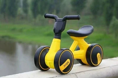 A stylish no-pedal balance bike with three wheels, vibrant colors, and optional light-up and music features for kids