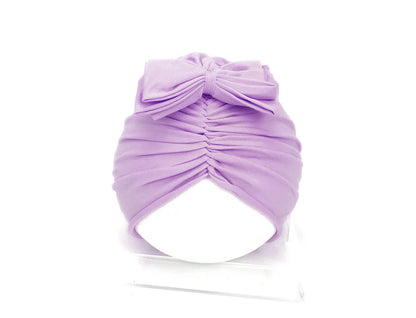 Soft acrylic knitted baby cap for newborns and toddlers in a solid colour, showing stretch fit.