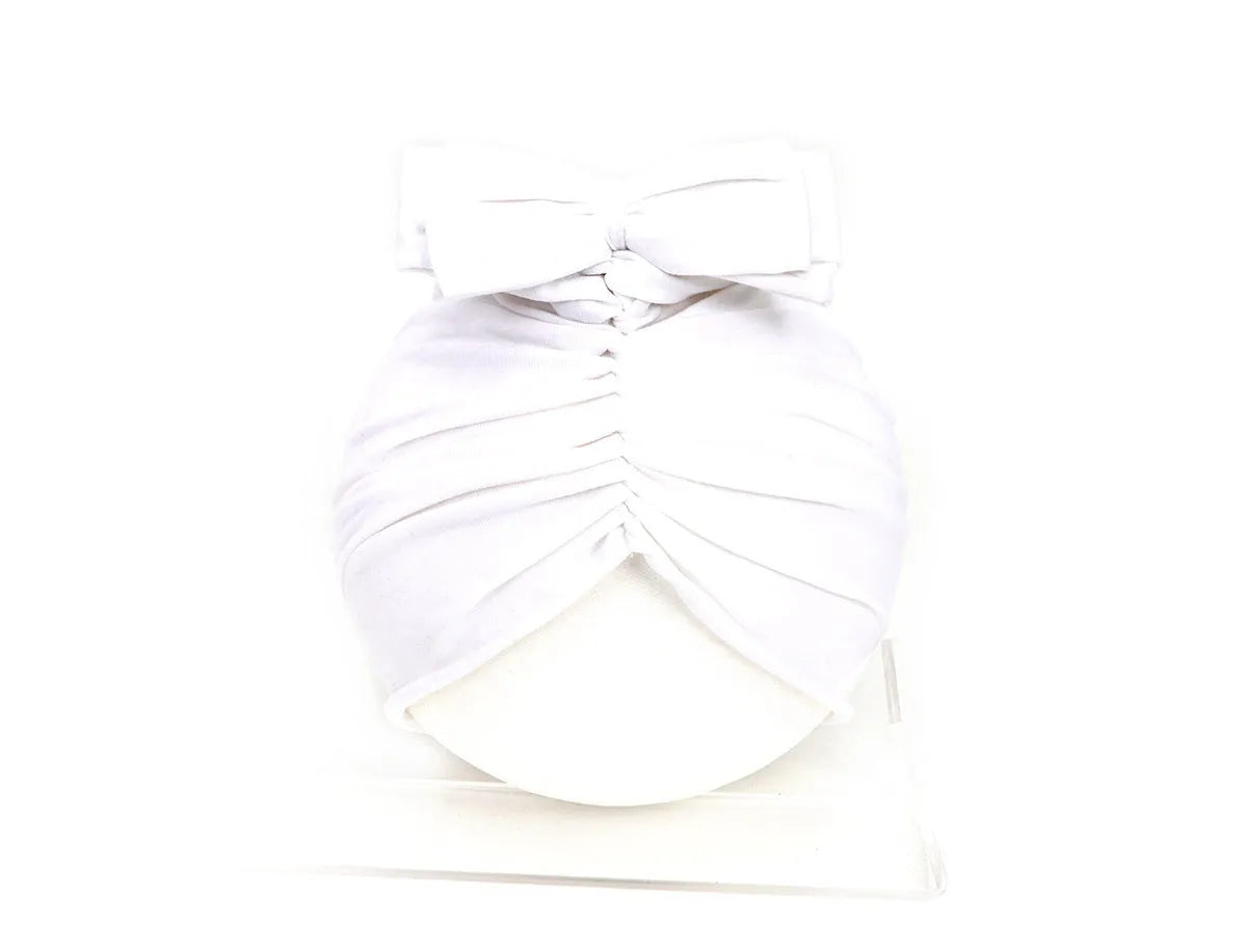 Soft acrylic knitted baby cap for newborns and toddlers in a solid colour, showing stretch fit.