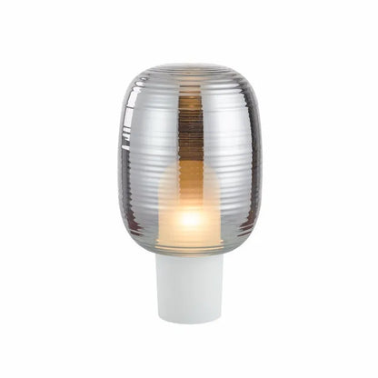 Transparent glass table lamp with modern Nordic design in cognac colour on wooden surface