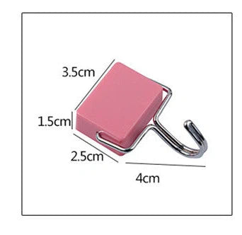 Yellow magnetic plastic hook with 4cm diameter base on metal surface holding kitchen utensils