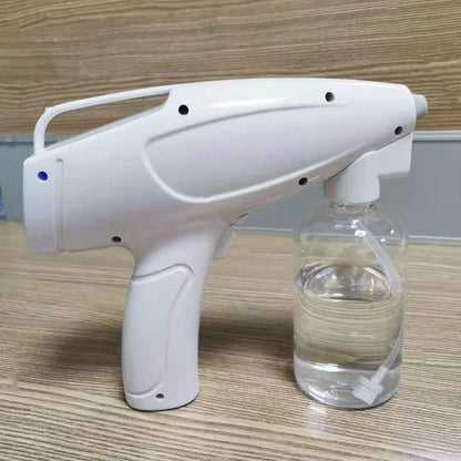White handheld cordless electric disinfection sprayer with USB-C port and trigger, showing mist spray.